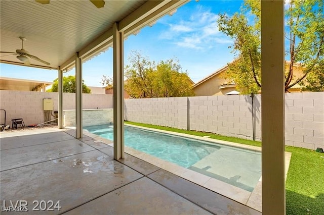 view of swimming pool featuring ceiling fan and a patio area