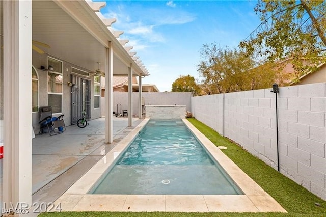 view of pool with ceiling fan and a patio area