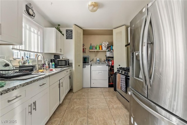 kitchen featuring light tile patterned floors, appliances with stainless steel finishes, sink, and white cabinetry