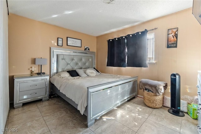 bedroom featuring a textured ceiling and light tile patterned floors