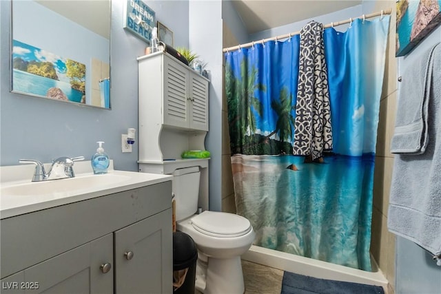 bathroom featuring toilet, vanity, and a shower with curtain