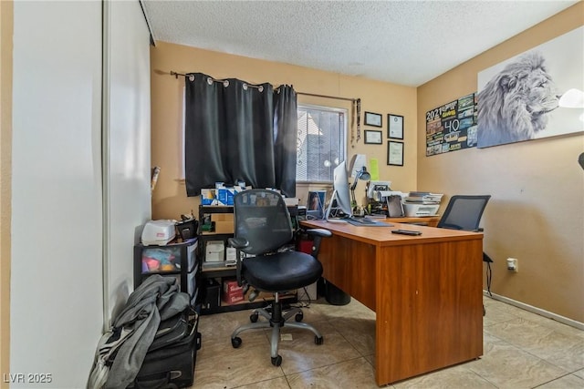 office space with a textured ceiling and light tile patterned floors