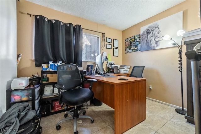 office area featuring a textured ceiling and light tile patterned flooring