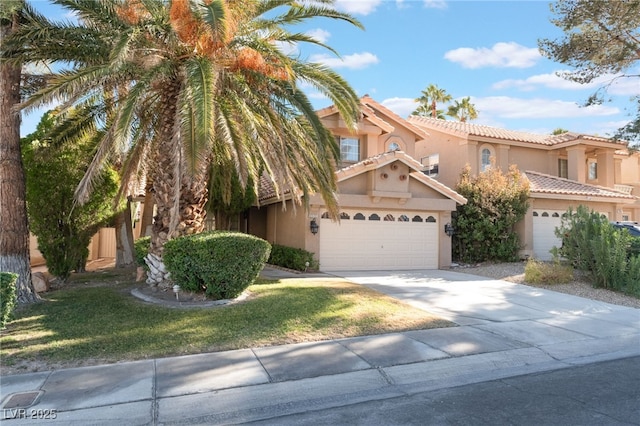 view of front of property featuring a garage and a front lawn