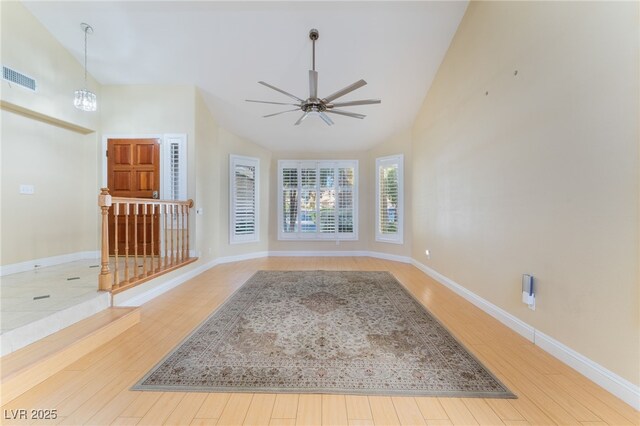 empty room featuring ceiling fan, hardwood / wood-style flooring, and lofted ceiling