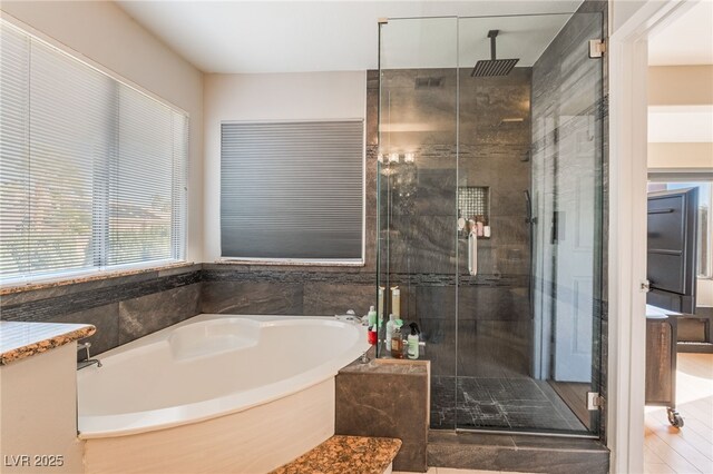 bathroom with vanity and shower with separate bathtub