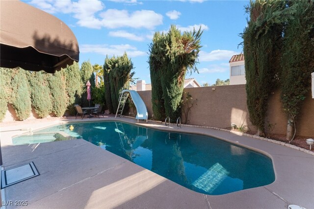 view of pool featuring a patio area and a water slide