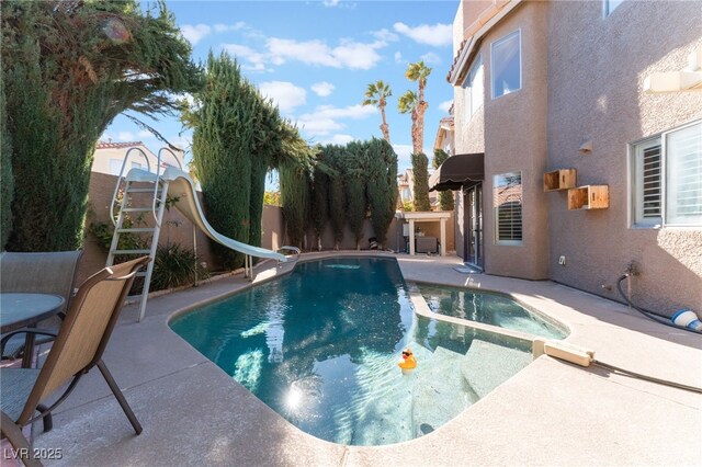 view of pool with a patio area and a water slide