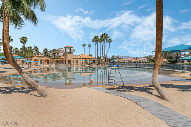 view of swimming pool featuring a water view