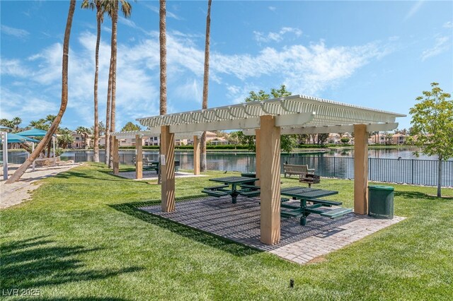 view of community with a water view, a lawn, and a pergola