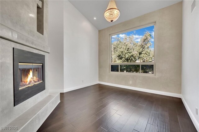 unfurnished living room with dark wood-type flooring