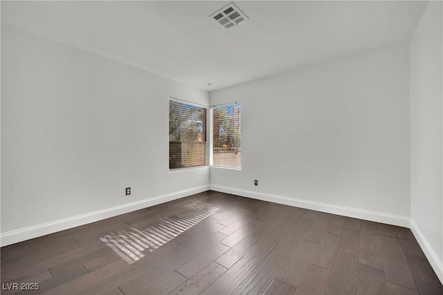 spare room featuring dark hardwood / wood-style floors