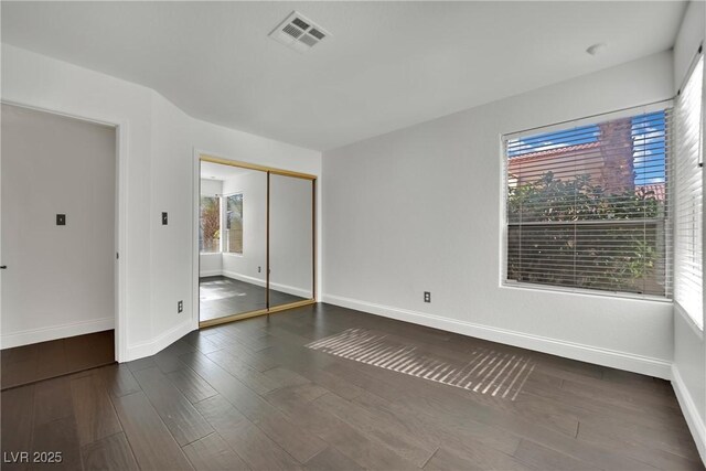 empty room featuring dark hardwood / wood-style flooring