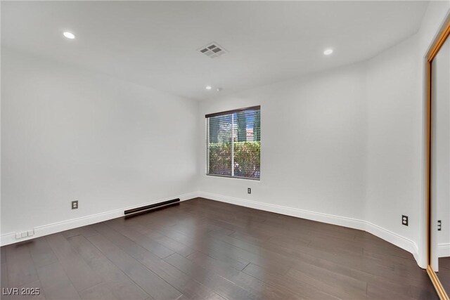 spare room with dark wood-type flooring