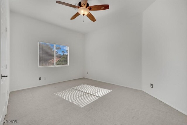 empty room with ceiling fan and light colored carpet