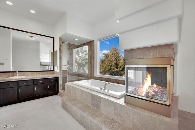 bathroom featuring vanity and separate shower and tub