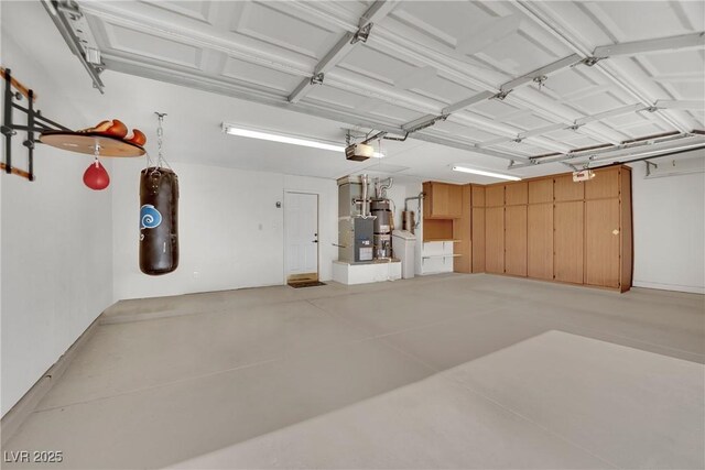 garage with a garage door opener and secured water heater