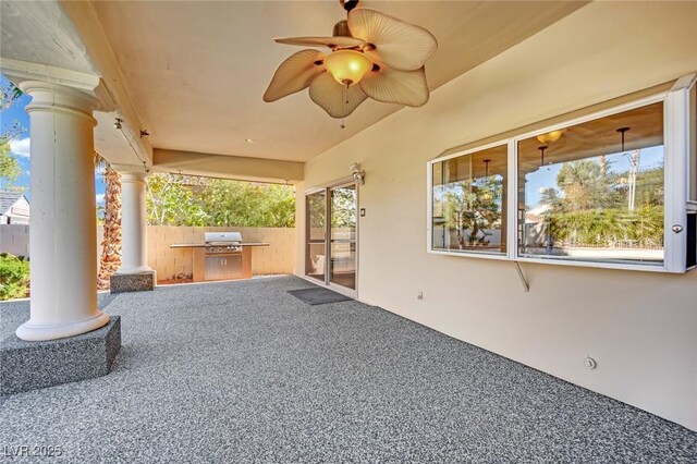 view of patio / terrace with ceiling fan, a grill, and an outdoor kitchen