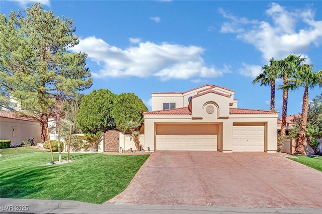 mediterranean / spanish-style house with a garage and a front lawn