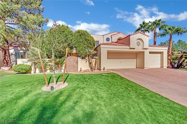 mediterranean / spanish house with a front lawn and a garage