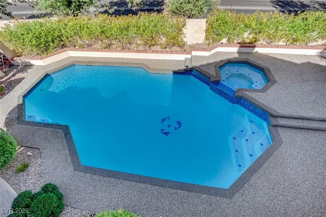 view of pool featuring an in ground hot tub