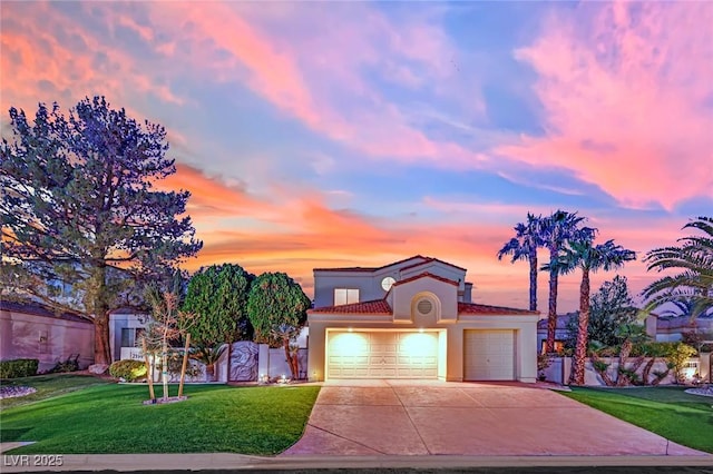 mediterranean / spanish-style house with a garage and a lawn