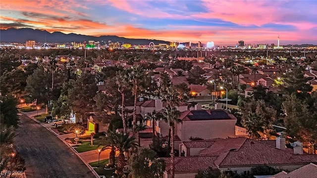 aerial view at dusk featuring a mountain view