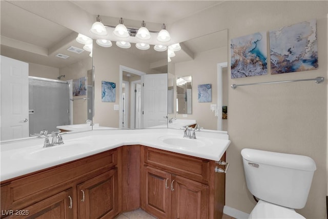 bathroom featuring a shower with shower door, toilet, and vanity