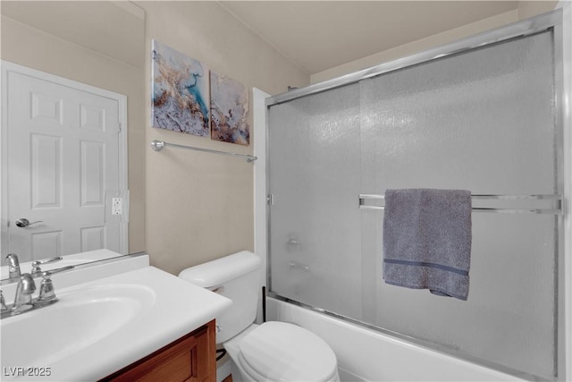 full bathroom featuring toilet, vanity, and combined bath / shower with glass door