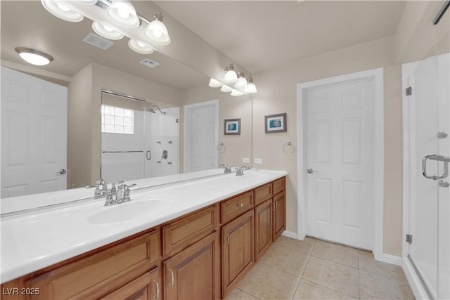 bathroom with vanity, tile patterned flooring, and a shower with door