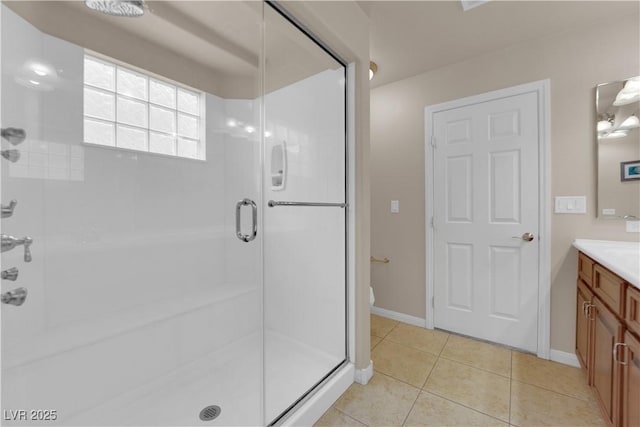 bathroom featuring walk in shower, vanity, tile patterned flooring, and toilet