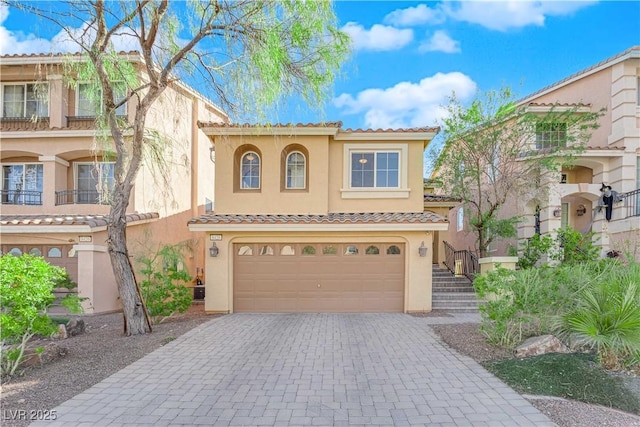 mediterranean / spanish-style house with a garage