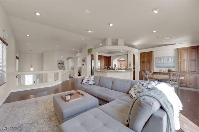 living room with vaulted ceiling and dark hardwood / wood-style flooring