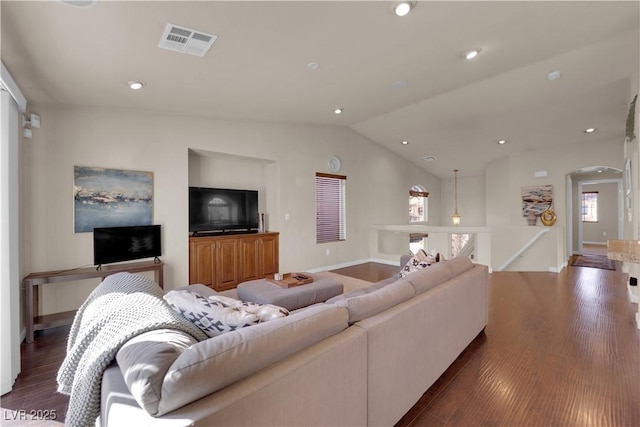 living room featuring lofted ceiling and dark hardwood / wood-style floors