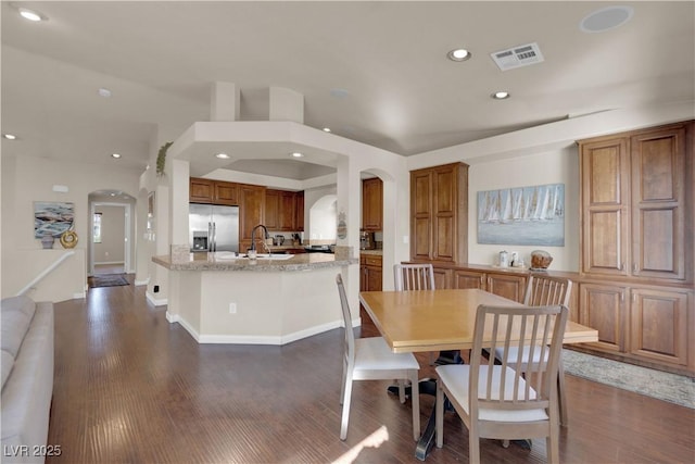 dining area with dark hardwood / wood-style flooring and sink