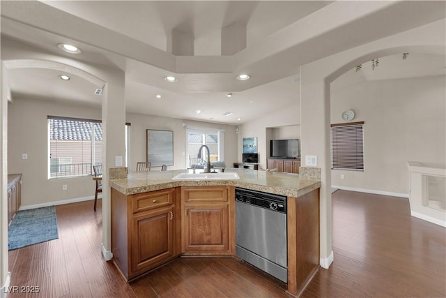 kitchen with sink, stainless steel dishwasher, dark hardwood / wood-style floors, and a towering ceiling