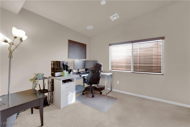 carpeted home office featuring lofted ceiling