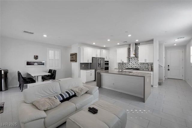 tiled living room featuring sink