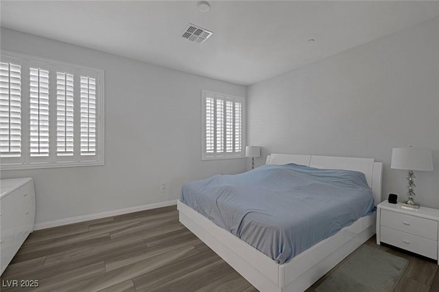 bedroom with dark hardwood / wood-style floors