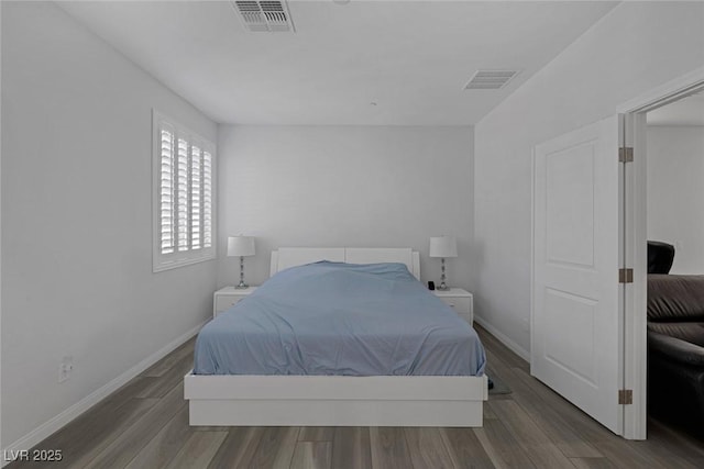 bedroom with hardwood / wood-style flooring