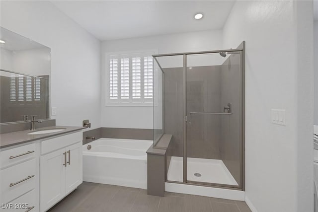 bathroom featuring separate shower and tub and vanity