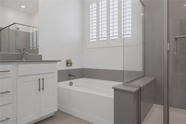 bathroom featuring vanity and shower with separate bathtub