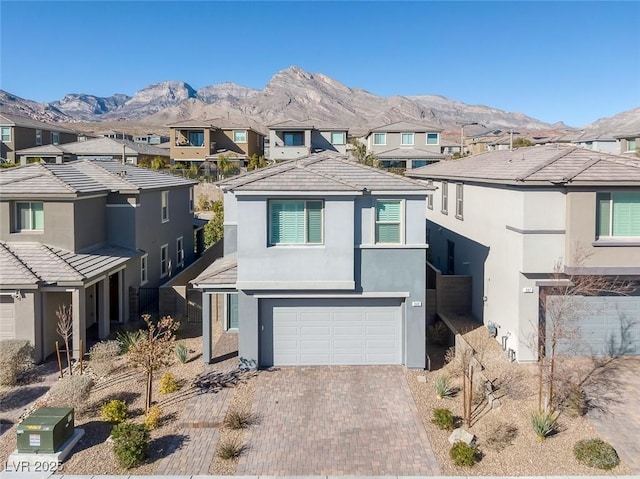 view of front facade featuring a garage and a mountain view