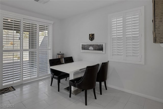 dining area with light tile patterned floors