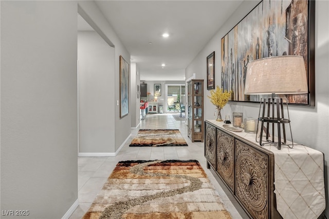 corridor with light tile patterned floors and french doors