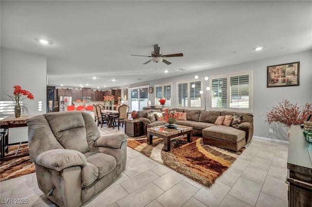 living room featuring ceiling fan and light tile patterned flooring