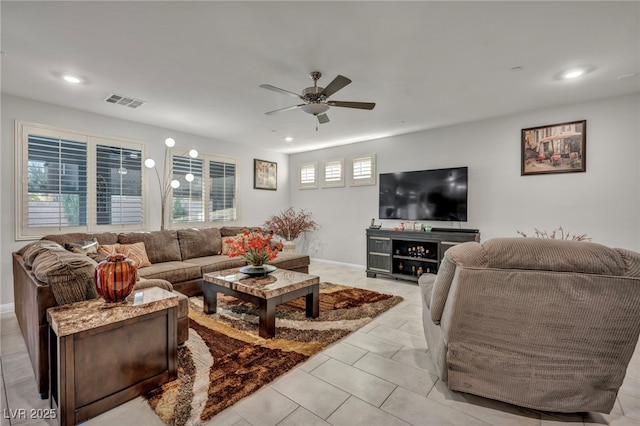 living room with ceiling fan and light tile patterned floors