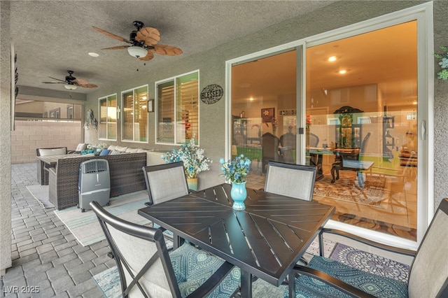 view of patio featuring ceiling fan and an outdoor living space