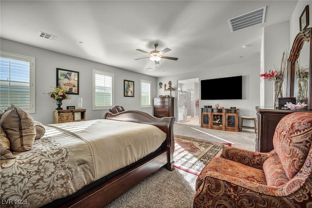 carpeted bedroom featuring ceiling fan and ensuite bathroom