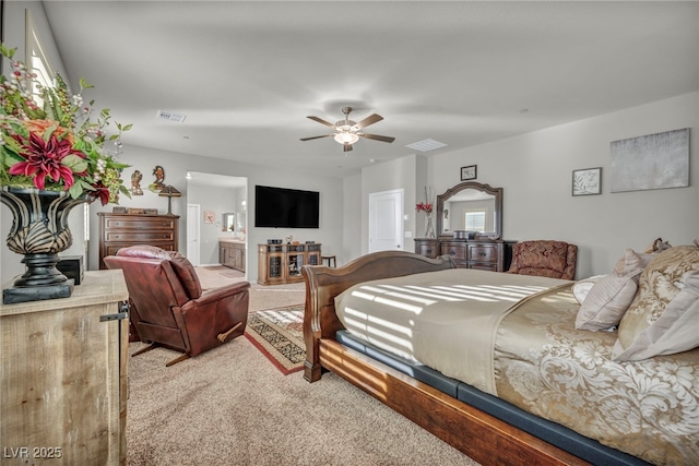 bedroom with ceiling fan, carpet, and connected bathroom